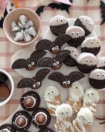 20 Halloween Party Food Ideas for a Spooky and Delicious Celebration 9 Oreo bats with candy eyes made with chocolate sandwich cookies, candy eyes, and simple chocolate decorations