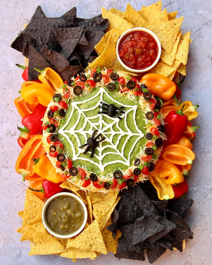 45 Halloween Potluck Recipes Everyone Will Want to Try 21 Spiderweb Seven-Layer Dip Board
